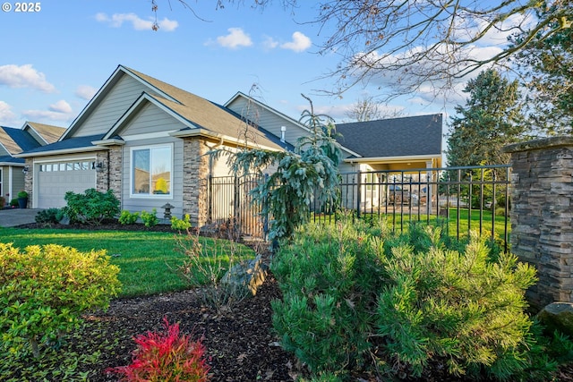 view of front of house featuring a garage and a front lawn