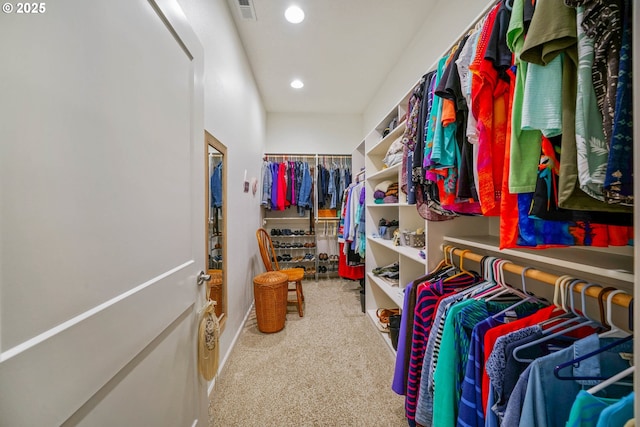 walk in closet with carpet flooring