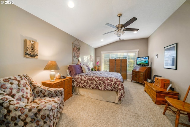 carpeted bedroom with vaulted ceiling and ceiling fan