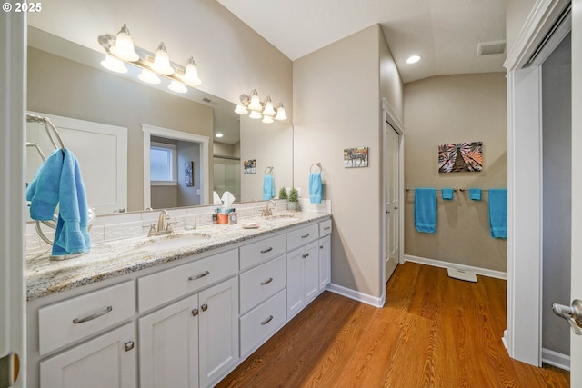 bathroom featuring hardwood / wood-style flooring and vanity