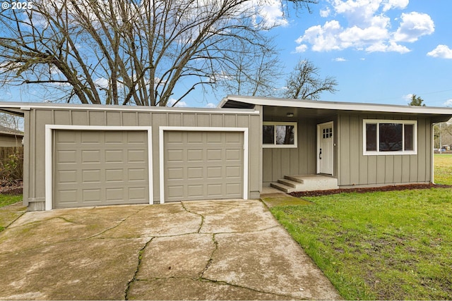 ranch-style home featuring a garage and a front lawn