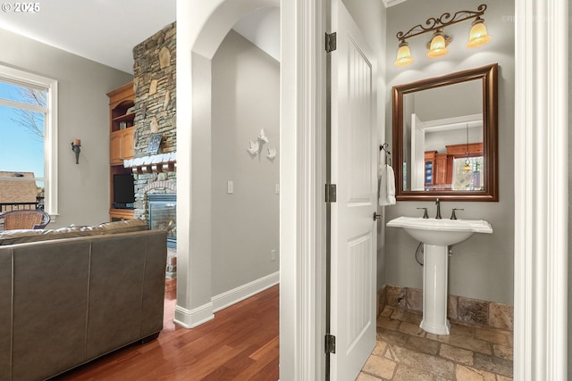 bathroom with baseboards and a fireplace