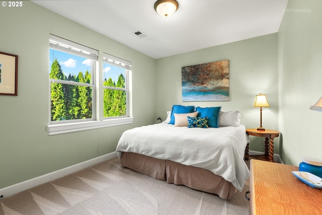 carpeted bedroom with baseboards and visible vents