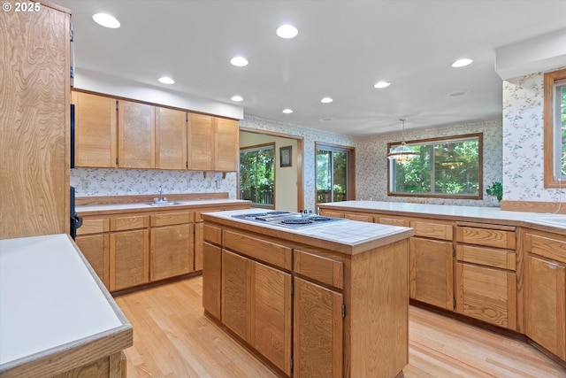 kitchen with a center island, a wealth of natural light, recessed lighting, light wood-type flooring, and wallpapered walls