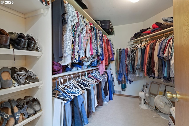 walk in closet with carpet flooring