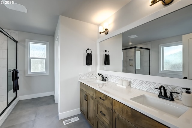 bathroom featuring vanity, backsplash, and a shower with shower door