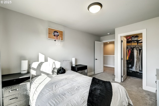 carpeted bedroom featuring a walk in closet and a closet