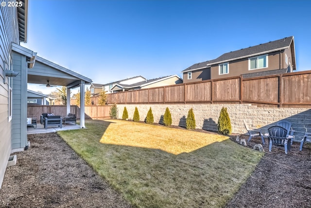 view of yard with a patio and ceiling fan