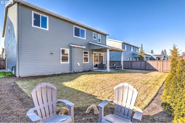 back of property featuring a yard and a patio area