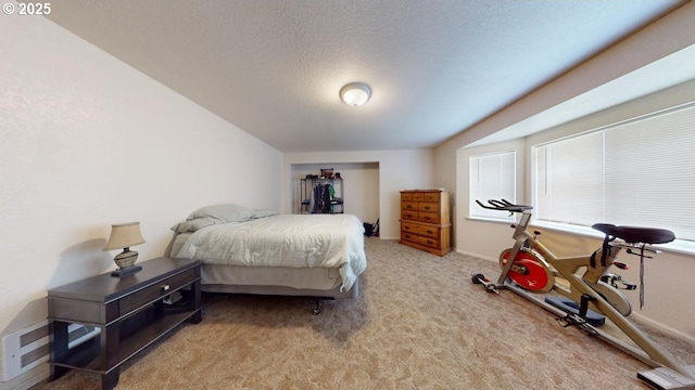 carpeted bedroom featuring visible vents, a textured ceiling, and baseboards