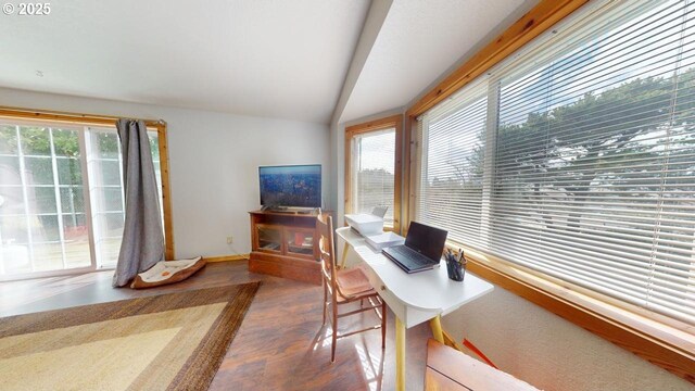 home office with baseboards, lofted ceiling, and wood finished floors