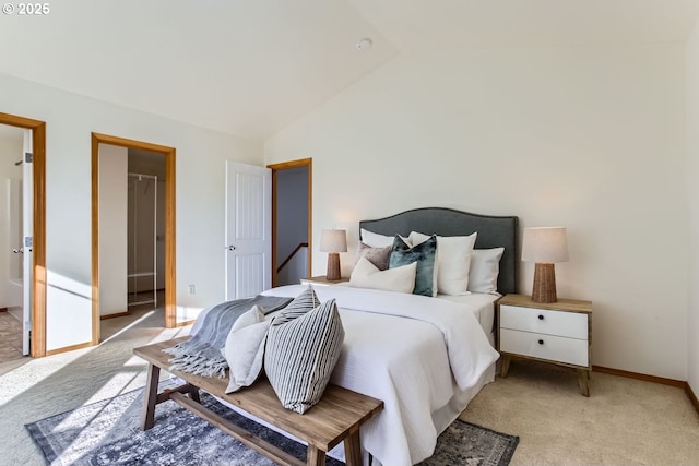 bedroom featuring vaulted ceiling and light carpet