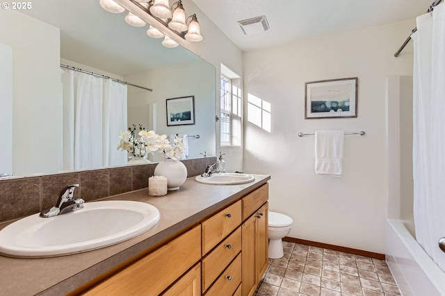 full bathroom featuring vanity, toilet, and shower / tub combo with curtain