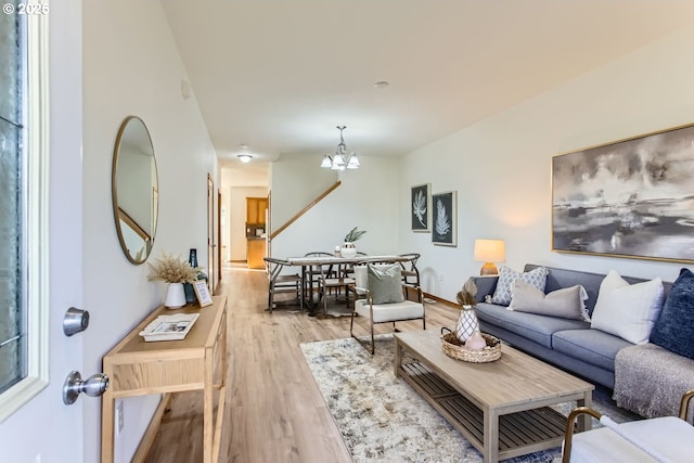 living room featuring an inviting chandelier and light hardwood / wood-style floors