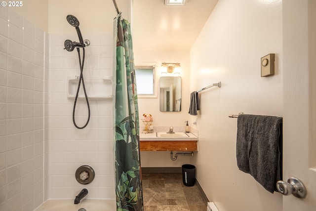 bathroom featuring a sink and shower / bathtub combination with curtain