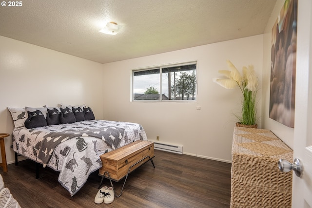 bedroom with baseboards, wood finished floors, a textured ceiling, and baseboard heating