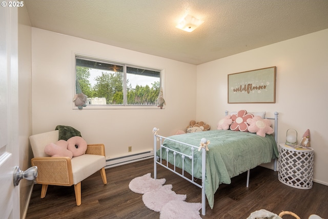 bedroom featuring baseboards, baseboard heating, wood finished floors, and a textured ceiling