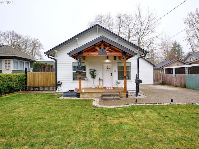 bungalow-style home with a patio area and a front yard