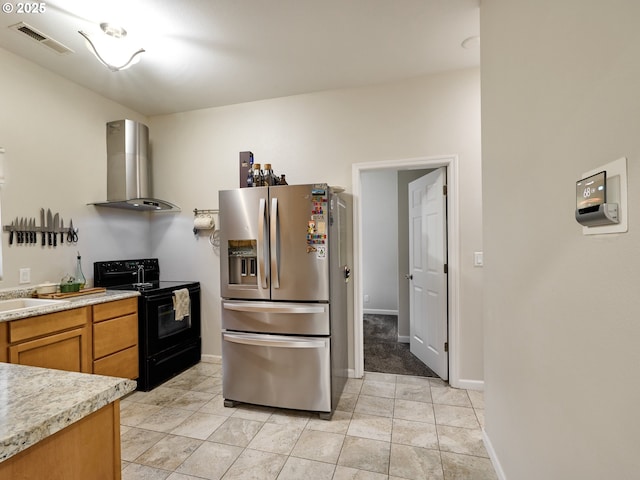 kitchen with stainless steel refrigerator with ice dispenser, sink, black range with electric stovetop, and wall chimney exhaust hood