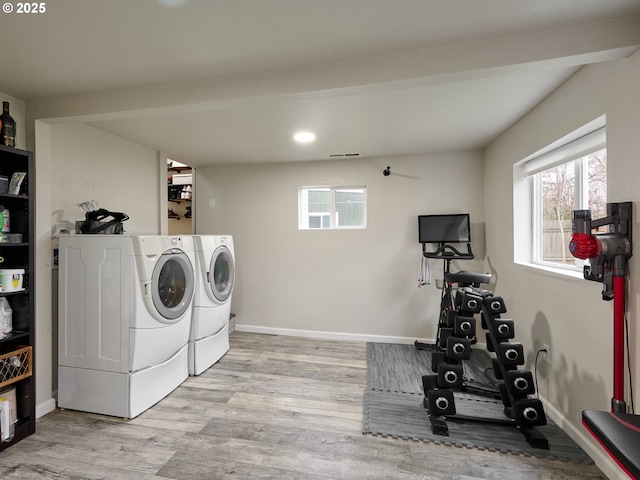 laundry room with light hardwood / wood-style flooring and independent washer and dryer