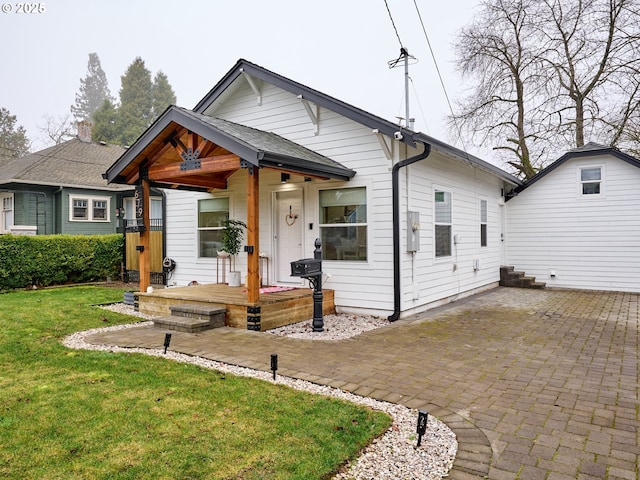 bungalow featuring a front yard and a porch