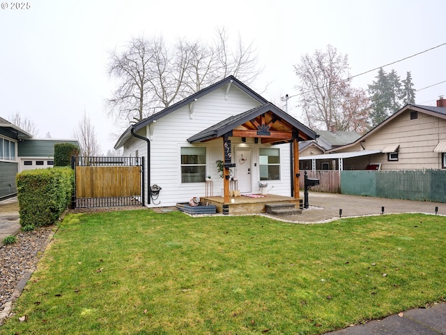 bungalow-style house featuring a patio and a front lawn