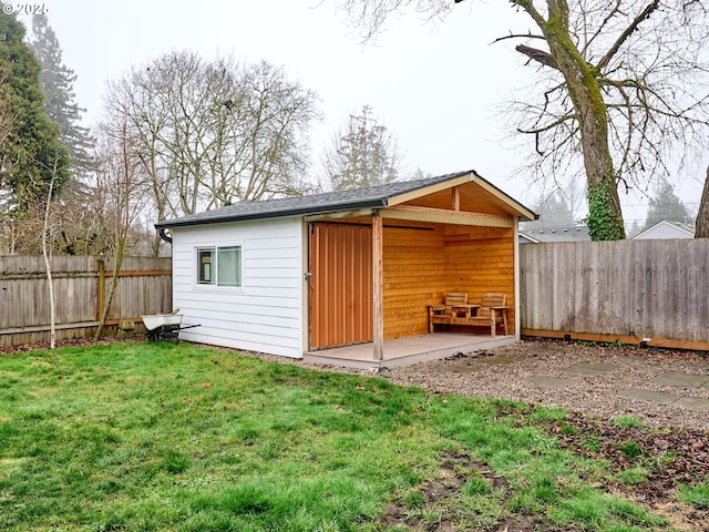 view of outbuilding featuring a lawn