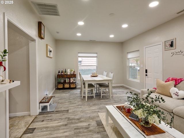 living room with a wealth of natural light and light wood-type flooring