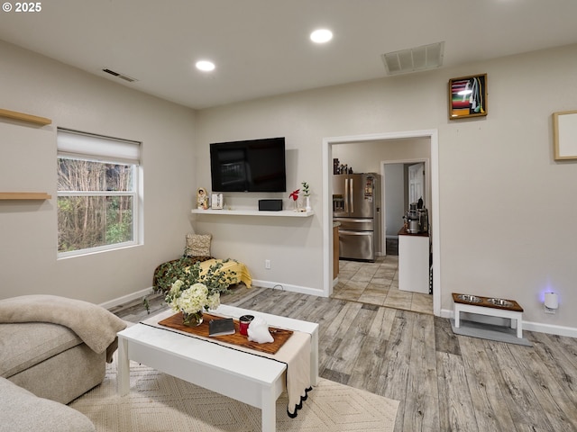 living room with light hardwood / wood-style floors