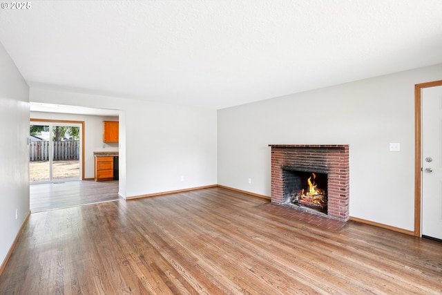 3259 SE 176th Pl, Portland, OR 97236 - unfurnished living room featuring light wood-style floors and a brick fireplace