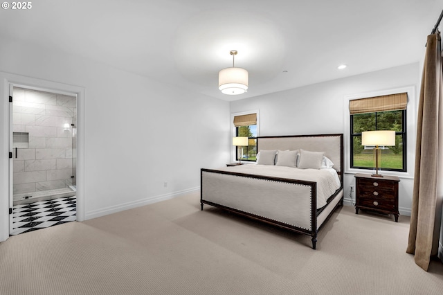 bedroom featuring connected bathroom, multiple windows, baseboards, and carpet flooring