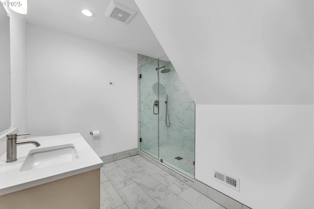 bathroom featuring vanity, visible vents, vaulted ceiling, marble finish floor, and a marble finish shower