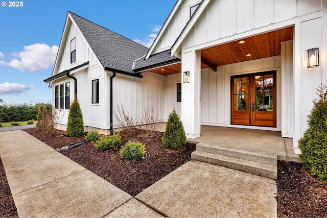 doorway to property featuring roof with shingles, french doors, board and batten siding, and a porch