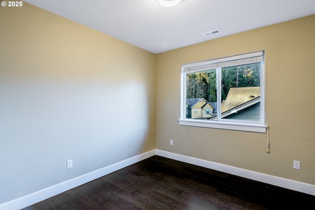 unfurnished room featuring dark wood-type flooring