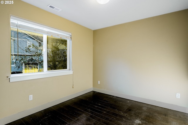 empty room featuring dark wood-type flooring