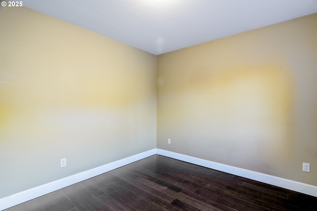 spare room with dark wood-type flooring