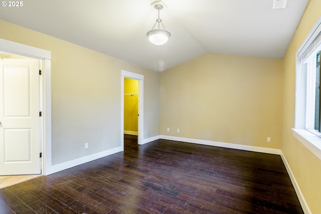 unfurnished room featuring dark hardwood / wood-style flooring and vaulted ceiling