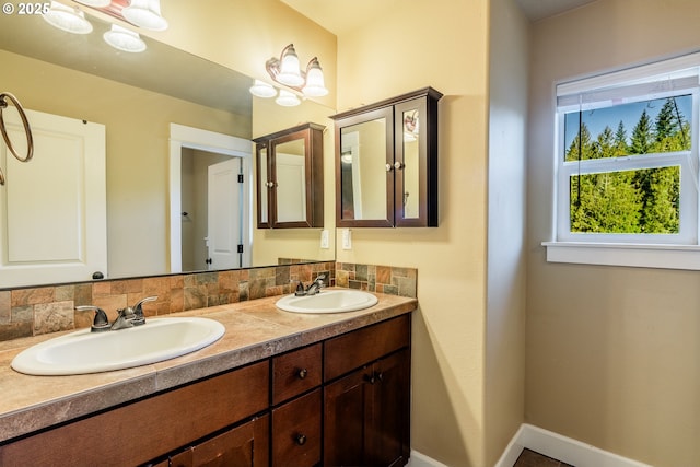 bathroom with vanity and decorative backsplash