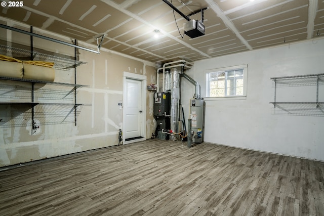 garage featuring a garage door opener and water heater