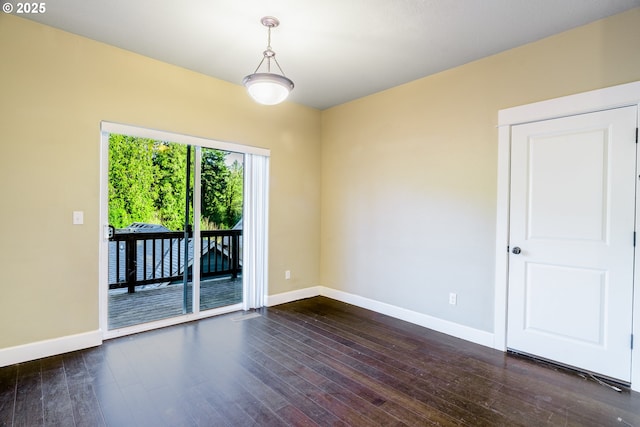 empty room featuring dark hardwood / wood-style flooring