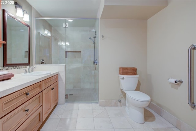 bathroom with tile patterned flooring, vanity, toilet, and an enclosed shower