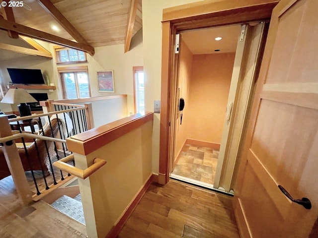 hallway featuring wood-type flooring, vaulted ceiling with beams, and wood ceiling