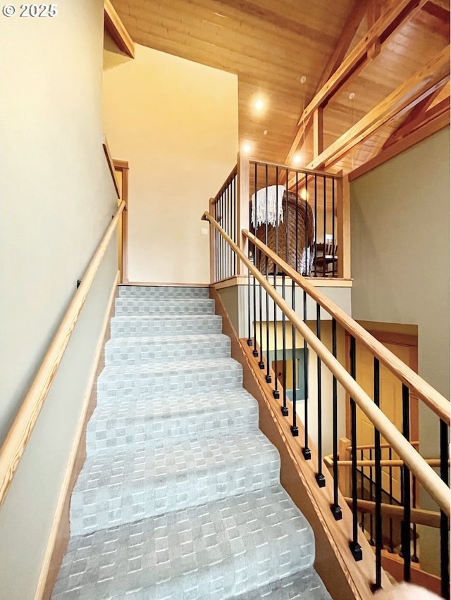 stairs with high vaulted ceiling and wooden ceiling