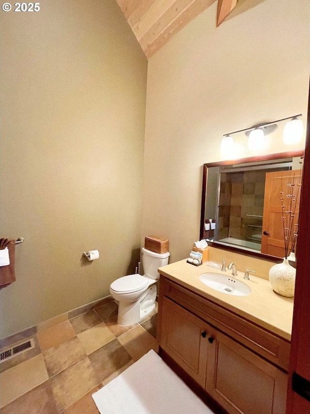 bathroom with vanity, toilet, and lofted ceiling