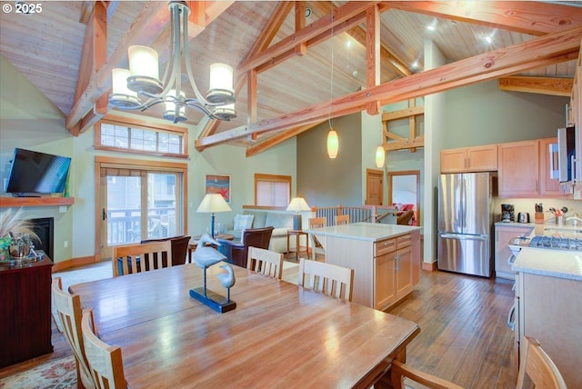 dining room featuring beamed ceiling, high vaulted ceiling, and a chandelier