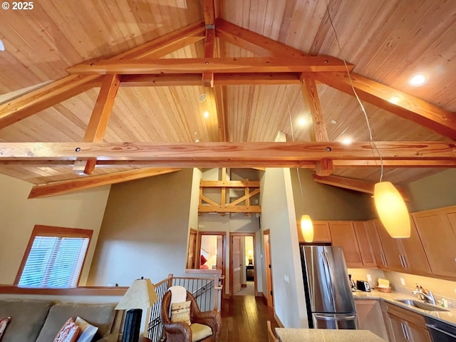 kitchen with beam ceiling, sink, stainless steel appliances, and hanging light fixtures