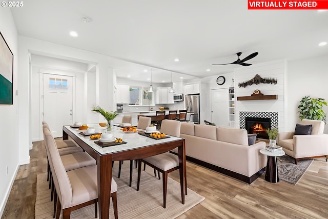 1046 SE Olive Way, Estacada, OR 97023 - dining space with light wood-style floors, a ceiling fan, recessed lighting, a tiled fireplace, and baseboards