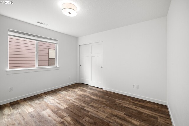 1046 SE Olive Way, Estacada, OR 97023 - unfurnished bedroom with dark wood-style flooring, baseboards, and a closet