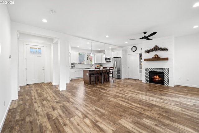 1046 SE Olive Way, Estacada, OR 97023 - living room featuring dark wood-style floors, ceiling fan, baseboards, recessed lighting, and a tile fireplace