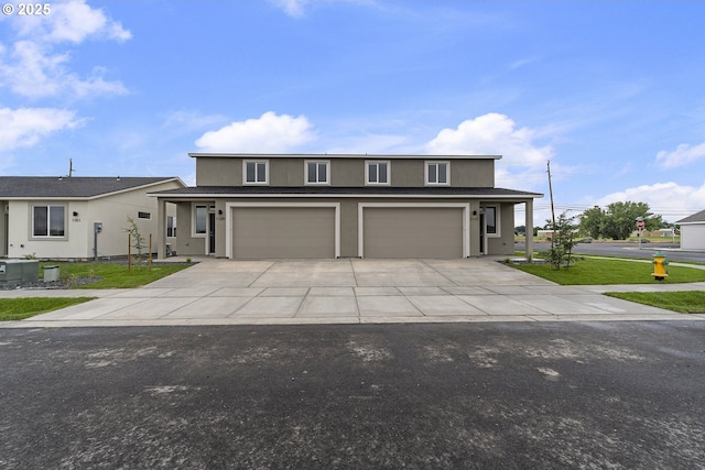 1129 NE Emerald Dr, Hermiston, OR 97838 - traditional home featuring an attached garage, concrete driveway, and stucco siding